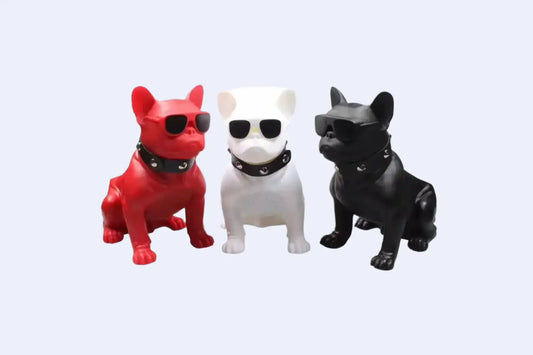 Three stylish Bulldog speaker figurines in red, white, and black, all wearing sunglasses and collars.