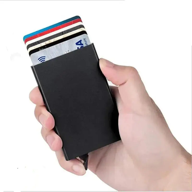Hand holding a sleek RFID smart wallet with cards showing, showcasing security and style.