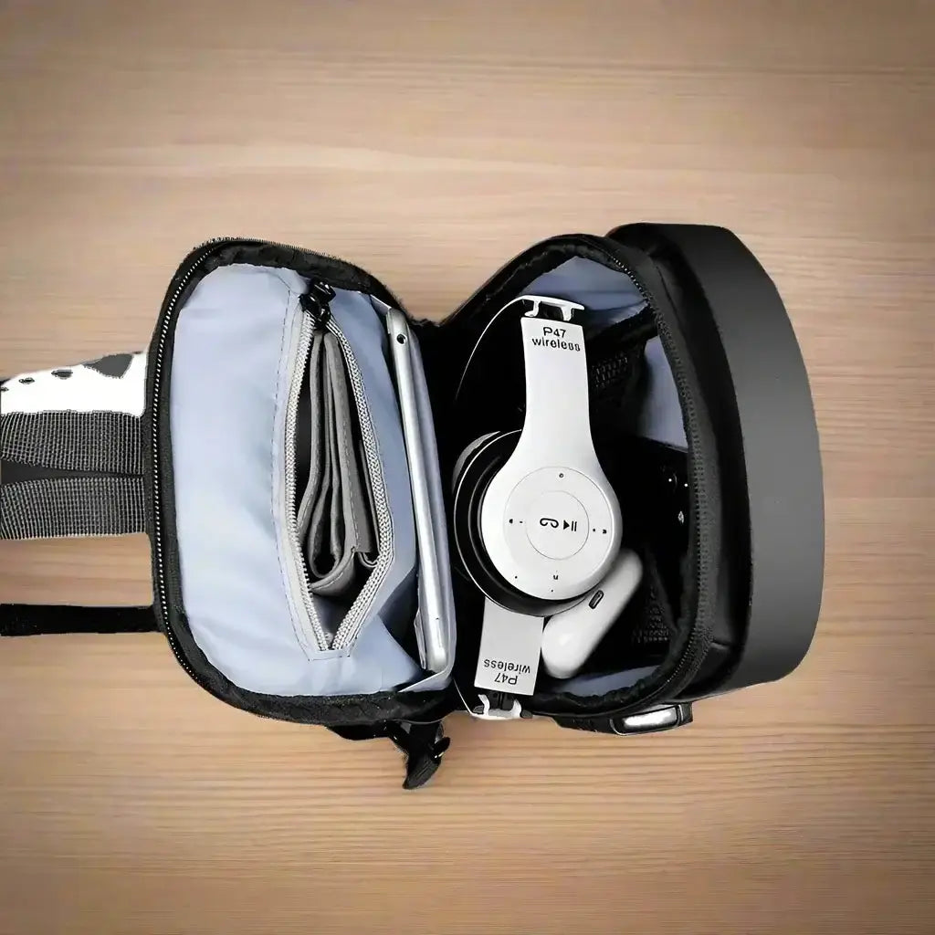 Interior of VoltGuard Chest Bag showing organized compartments with wireless headphones and accessories.